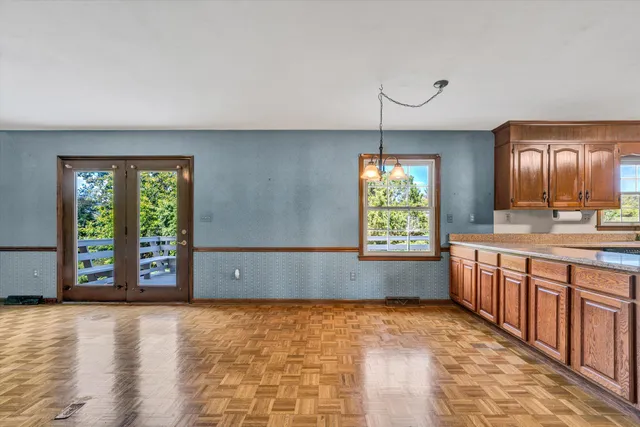 a kitchen with kitchen island granite countertop wooden cabinets a sink a stove and a refrigerator