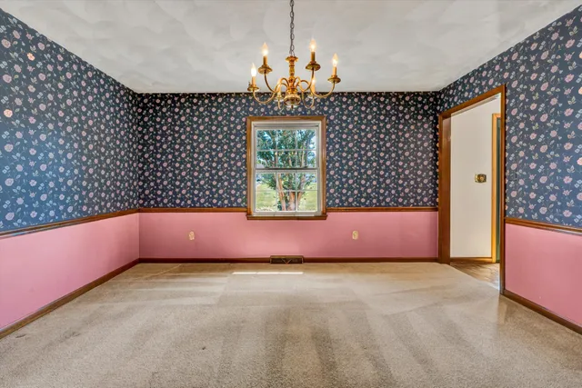 a hallway with granite countertop white cabinets and white appliances