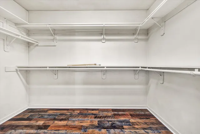 a view of an empty room and wooden floor