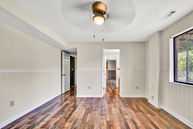 a front view of a house with a garden and yard