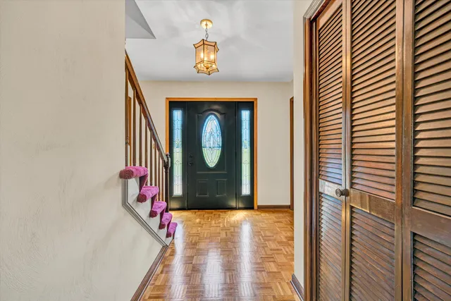 a view of entryway and hall with wooden floor