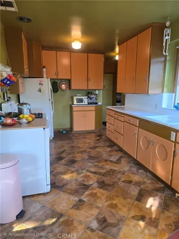 a large kitchen with kitchen island a sink a stove and a refrigerator