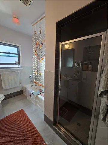 a bathroom with a toilet and a shower