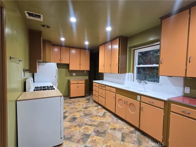 a kitchen with window and cabinets