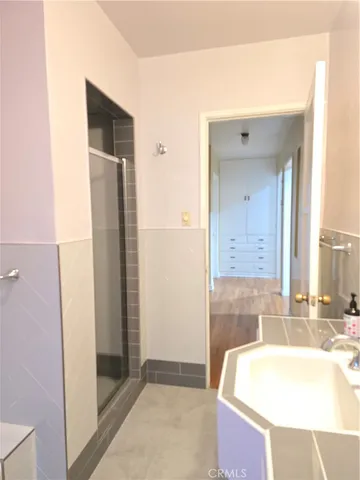 a bathroom with a glass shower door