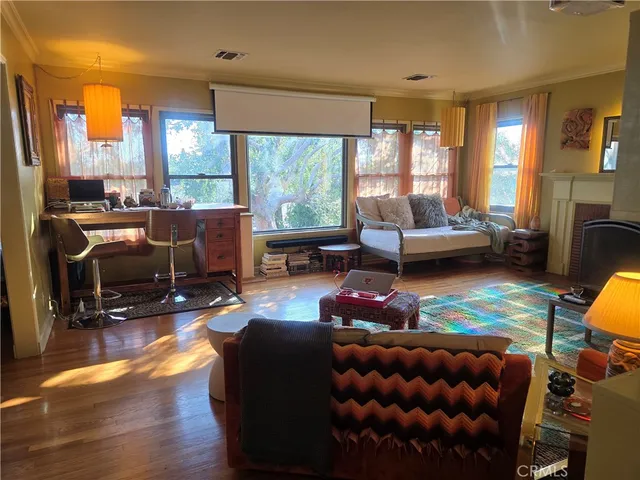 a living room with furniture a rug and a floor to ceiling window