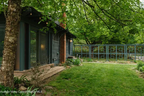 a view of a backyard with a large tree