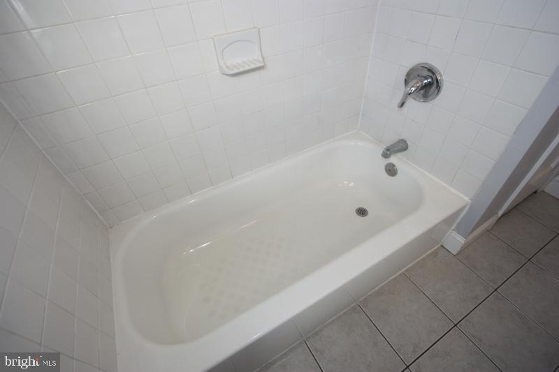 8110 Glen Gary Road Towson, MD 21286 - Photo 20 of 31 White tile, glazed porcelain tub, updated fixtures