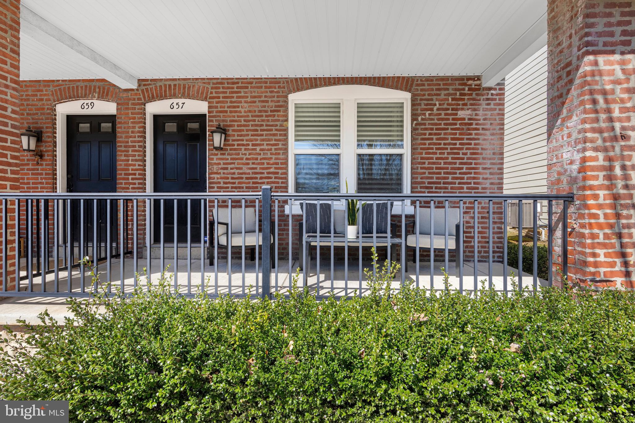 657 West End Walk Media, PA 19063 - Photo 2 of 26 a porch with a bench next to a yard