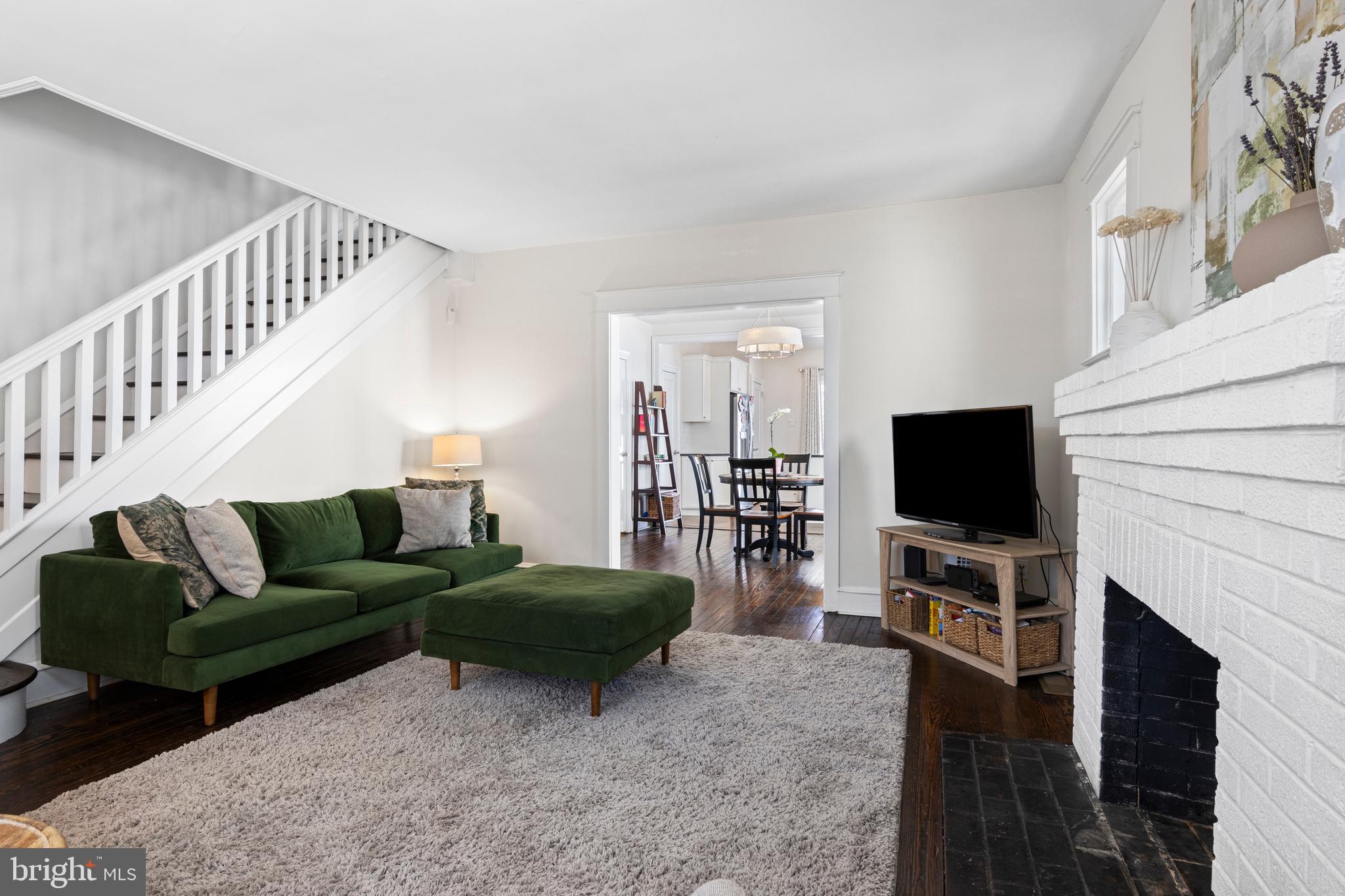 657 West End Walk Media, PA 19063 - Photo 6 of 26 a living room with furniture a flat screen tv and a fireplace