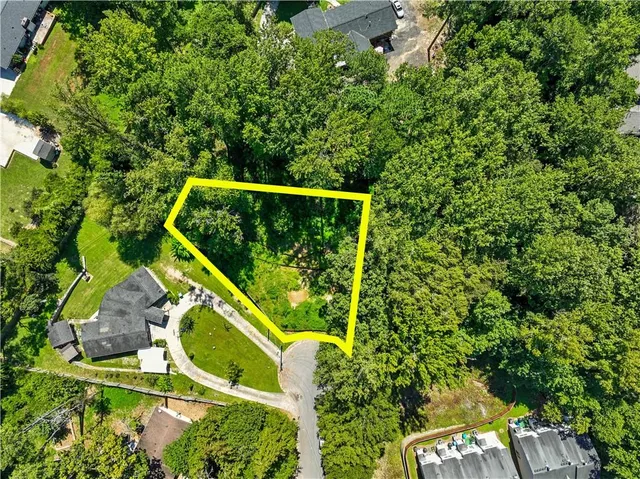 a view of a garden with a building in the background