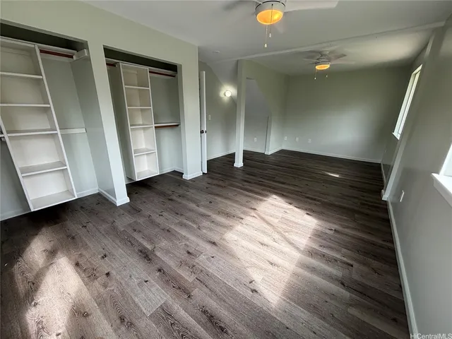 a view of an empty room and wooden floor