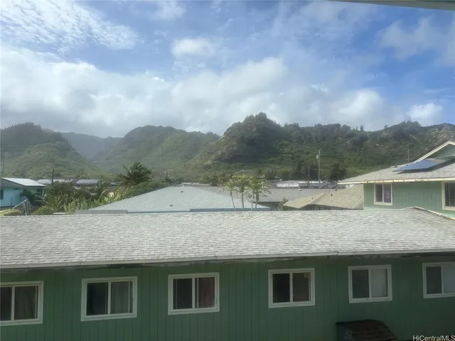 a view of a house with a yard and wooden fence