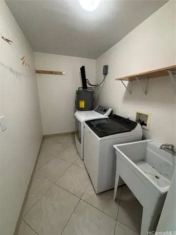 a utility room with sink dryer and washer