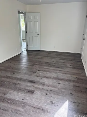 a view of wooden floor and window in a room