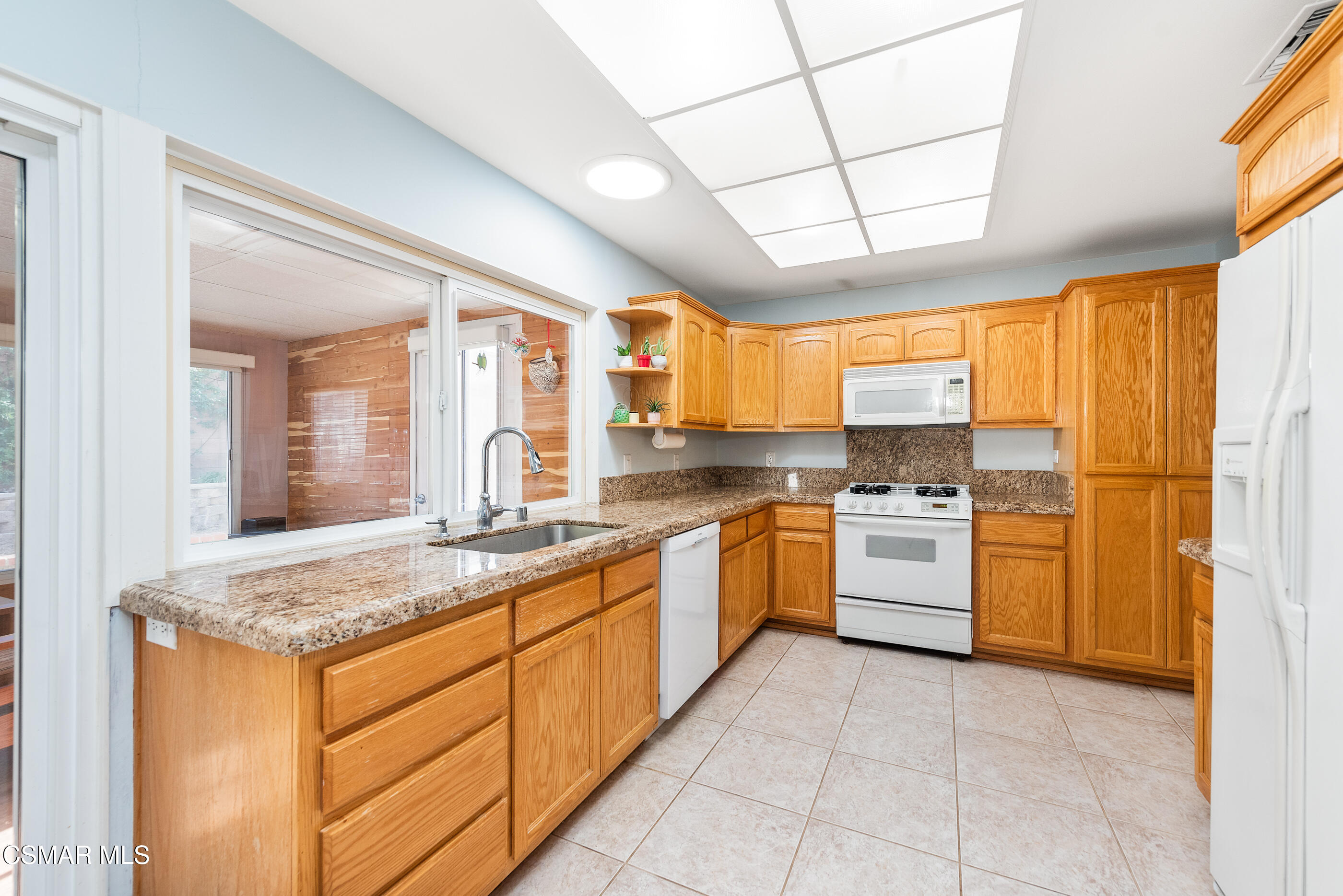 2226 Ecroyd Avenue Simi Valley, CA 93063 - Photo 17 of 52 a kitchen with stainless steel appliances granite countertop a refrigerator and a sink