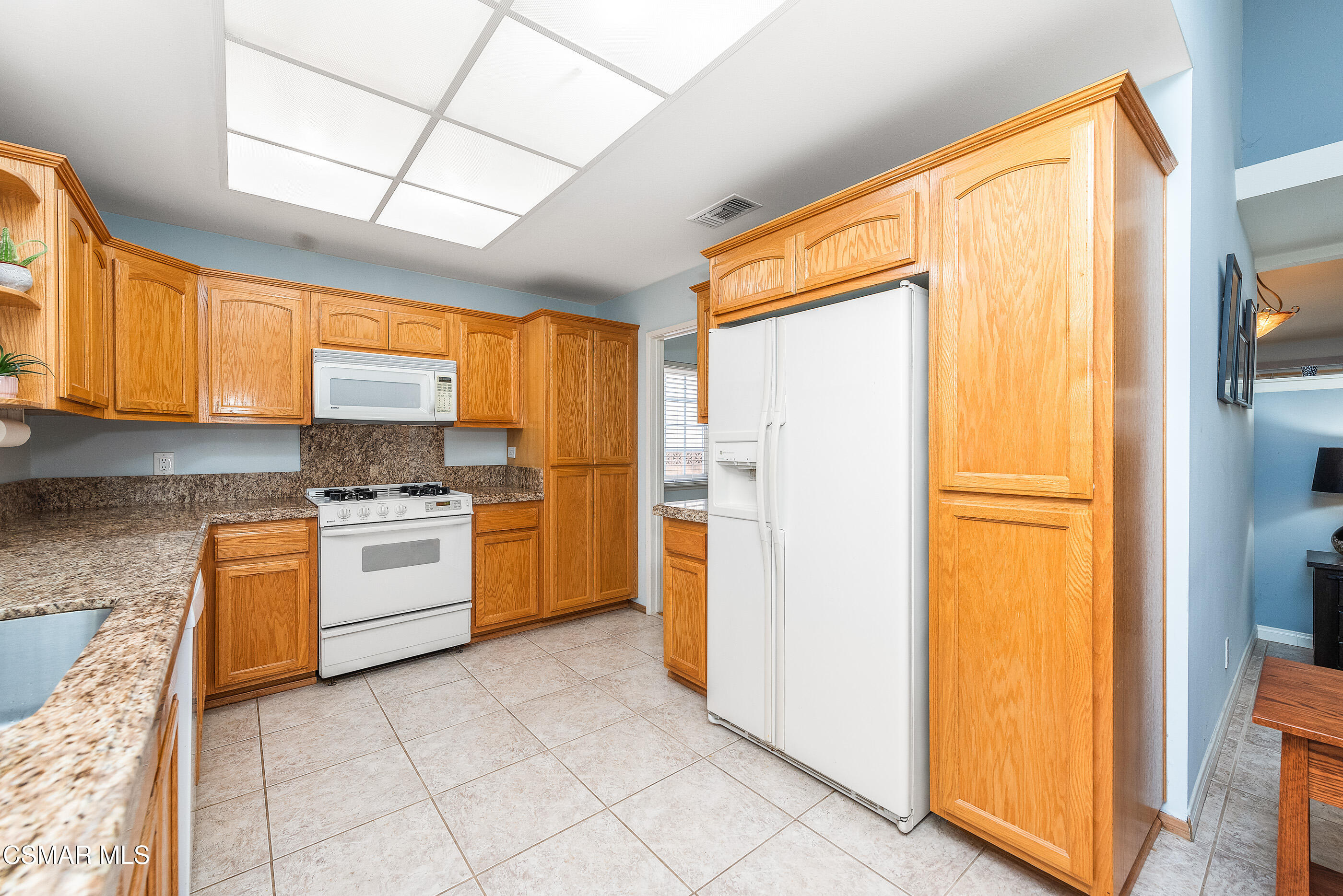 2226 Ecroyd Avenue Simi Valley, CA 93063 - Photo 18 of 52 a kitchen with stainless steel appliances granite countertop a refrigerator and a stove top oven