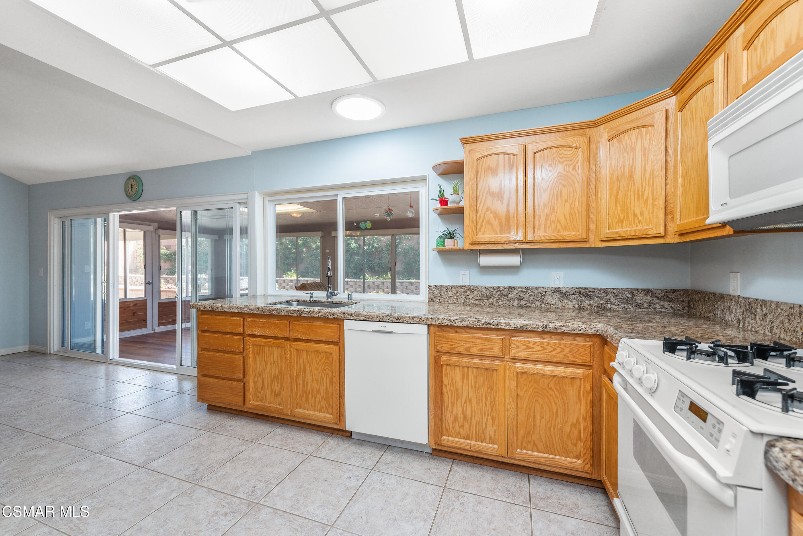 2226 Ecroyd Avenue Simi Valley, CA 93063 - Photo 19 of 52 a kitchen with stainless steel appliances granite countertop a stove a sink and a microwave