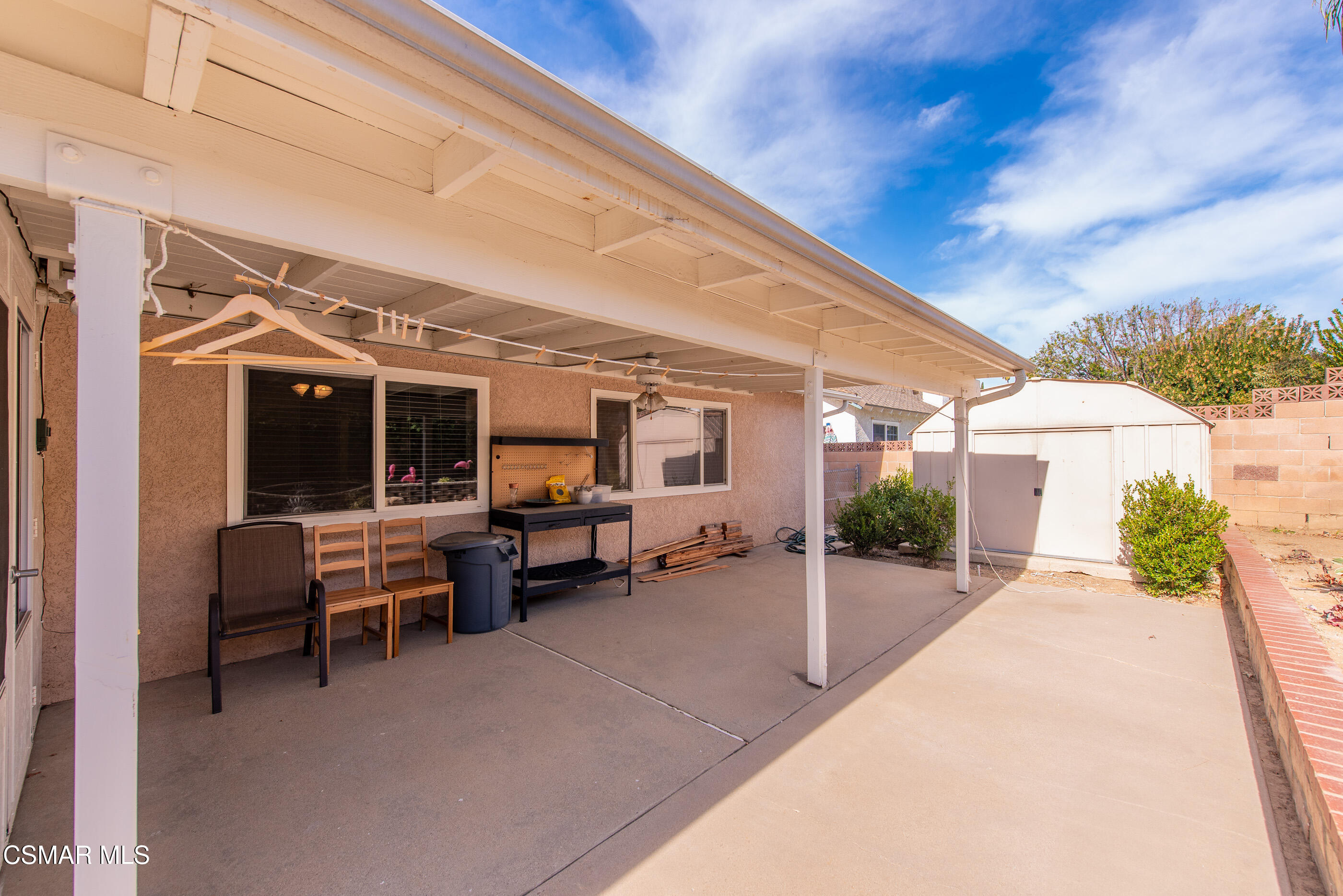 2226 Ecroyd Avenue Simi Valley, CA 93063 - Photo 25 of 52 a view of a patio with table and chairs potted plants and a floor to ceiling window