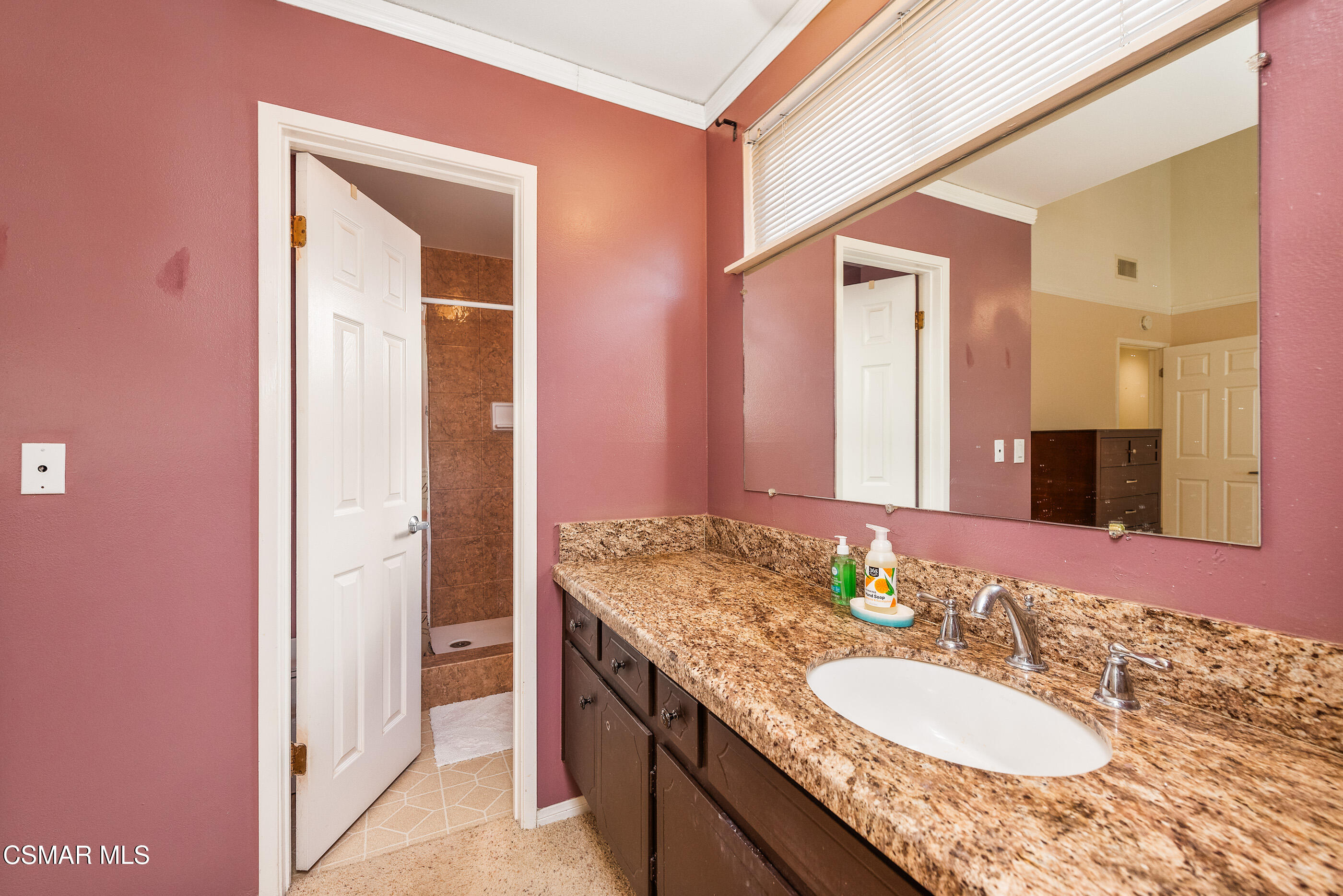2226 Ecroyd Avenue Simi Valley, CA 93063 - Photo 33 of 52 a bathroom with a granite countertop sink and a mirror