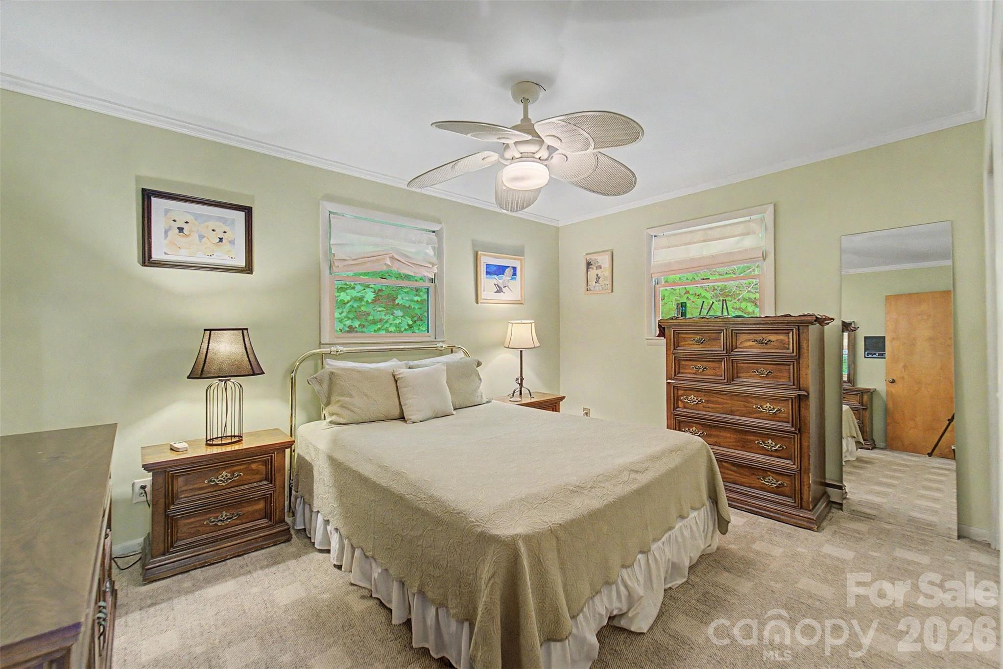 1413 Kitchens Branch Road Sylva, NC 28779 - Photo 14 of 46 a bedroom with a bed and a chandelier