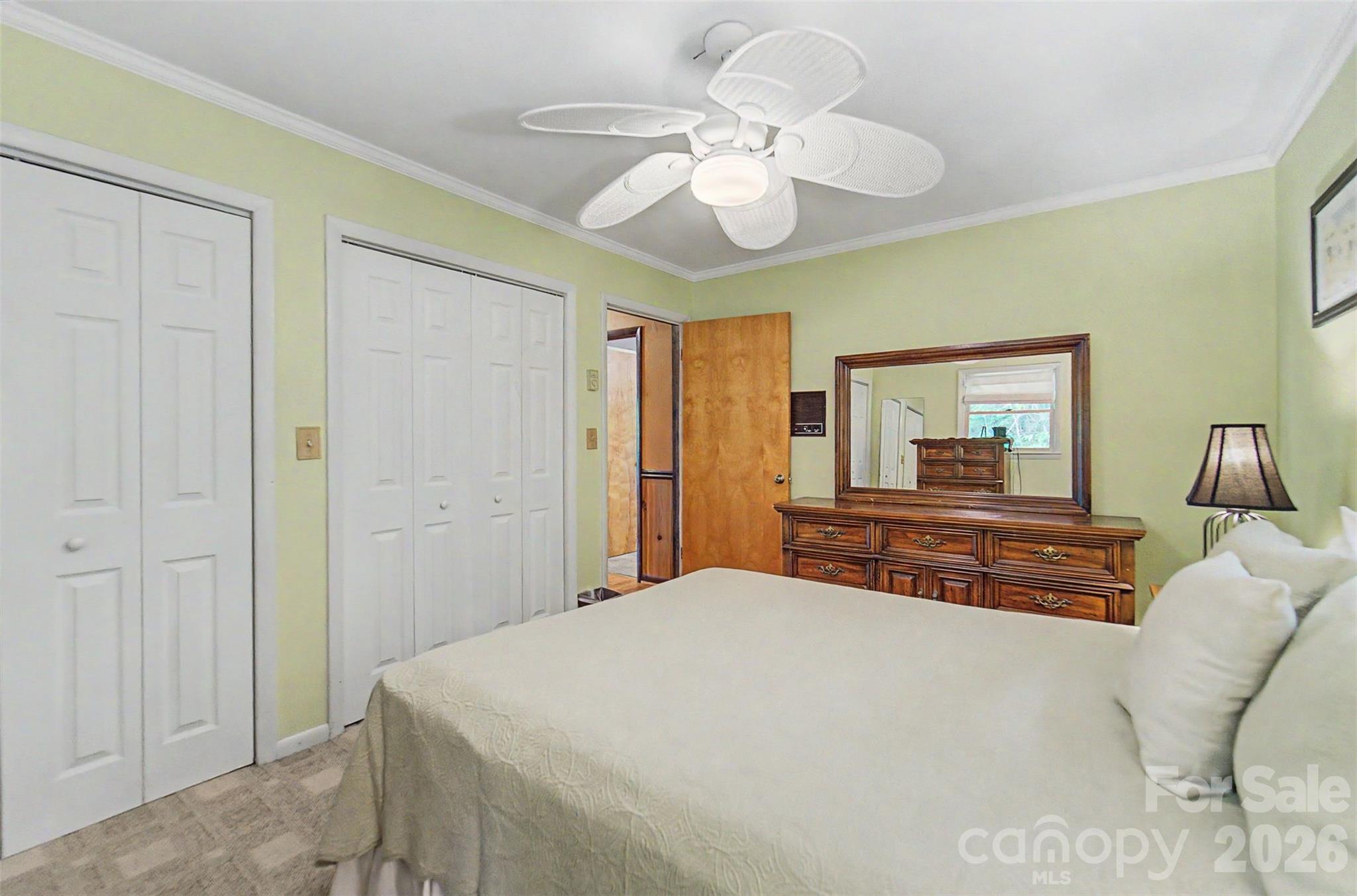1413 Kitchens Branch Road Sylva, NC 28779 - Photo 15 of 46 a bedroom with a large bed and a chandelier