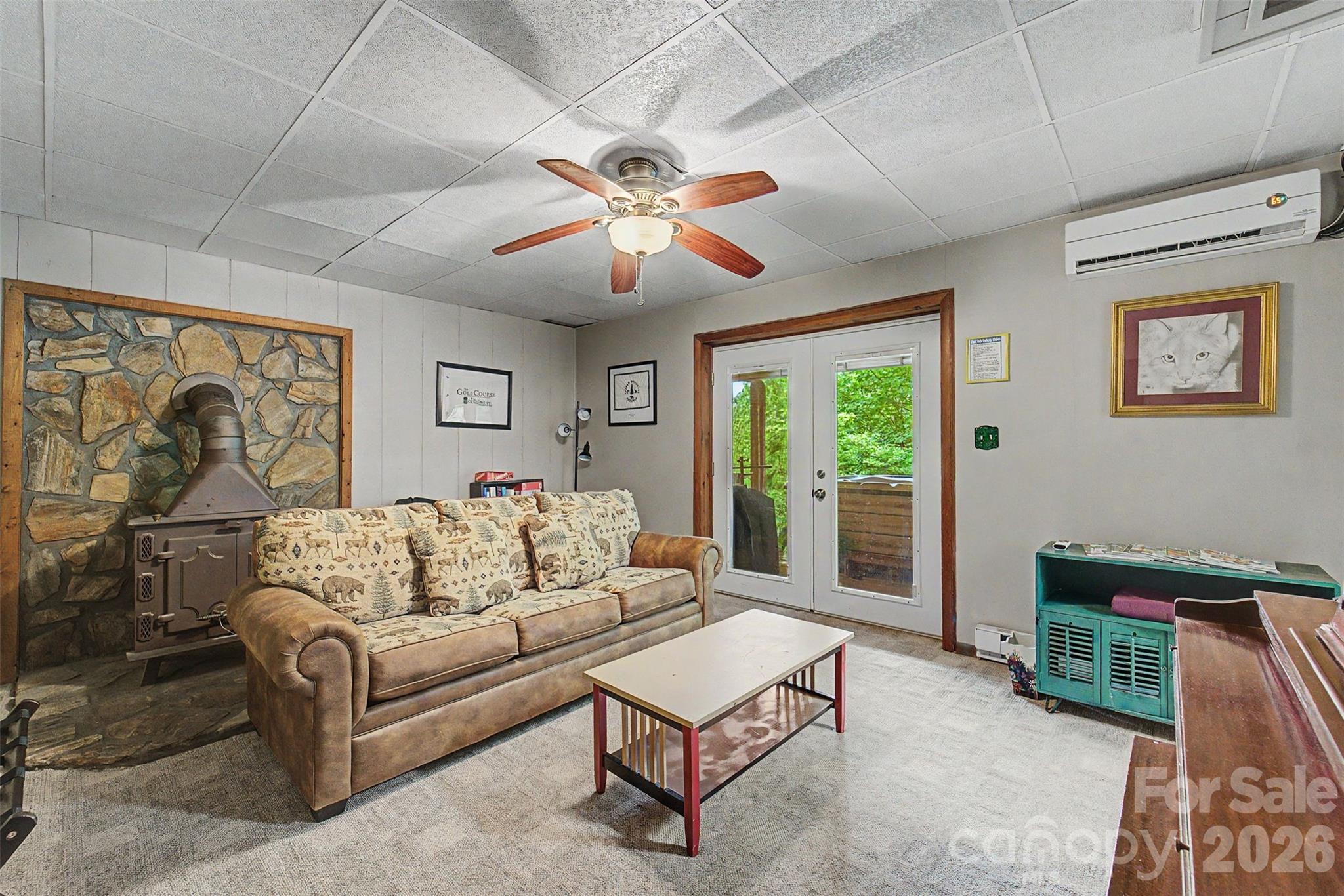 1413 Kitchens Branch Road Sylva, NC 28779 - Photo 20 of 46 a living room with furniture ceiling fan and a window