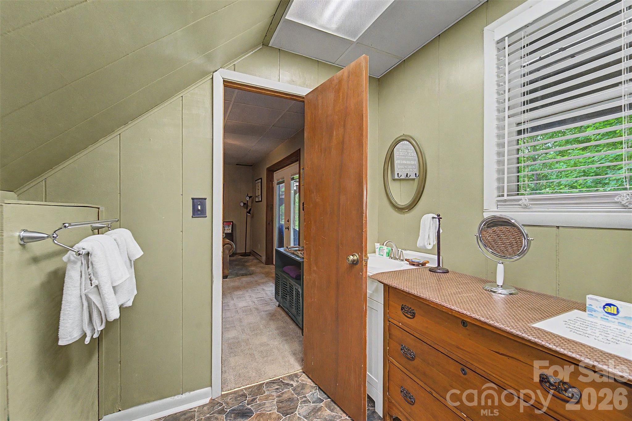 1413 Kitchens Branch Road Sylva, NC 28779 - Photo 24 of 46 a bathroom with a sink and a mirror