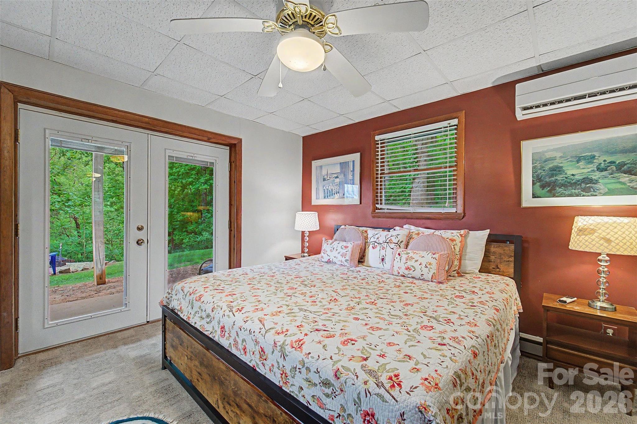 1413 Kitchens Branch Road Sylva, NC 28779 - Photo 25 of 46 a bedroom with a large bed and a chandelier