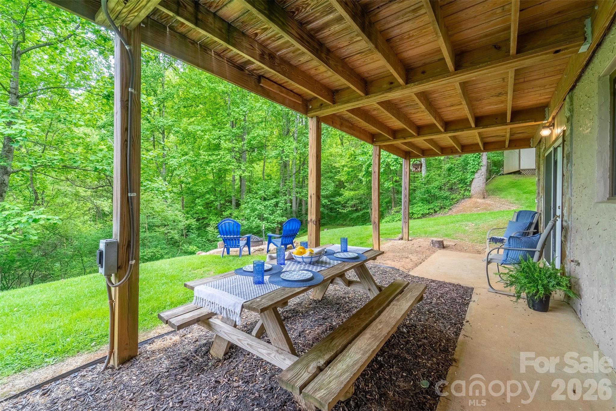 1413 Kitchens Branch Road Sylva, NC 28779 - Photo 27 of 46 a wooden bench sitting in front of a house