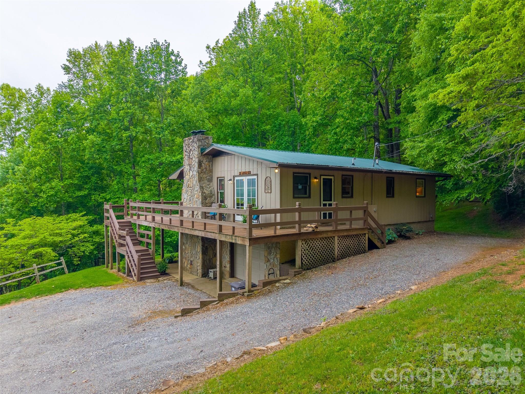 1413 Kitchens Branch Road Sylva, NC 28779 - Photo 35 of 46 a view of a house with a yard and deck area