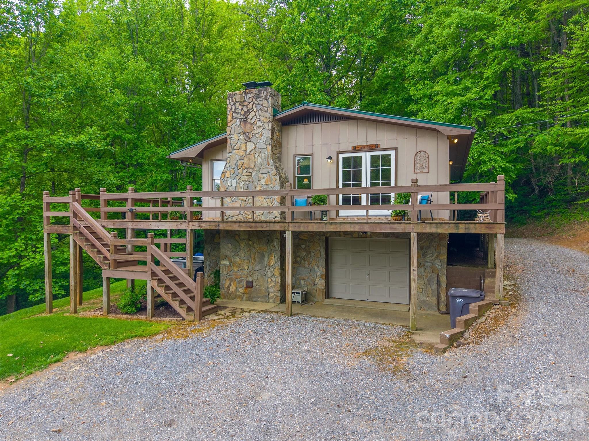 1413 Kitchens Branch Road Sylva, NC 28779 - Photo 36 of 46 a view of a house with a yard and sitting area