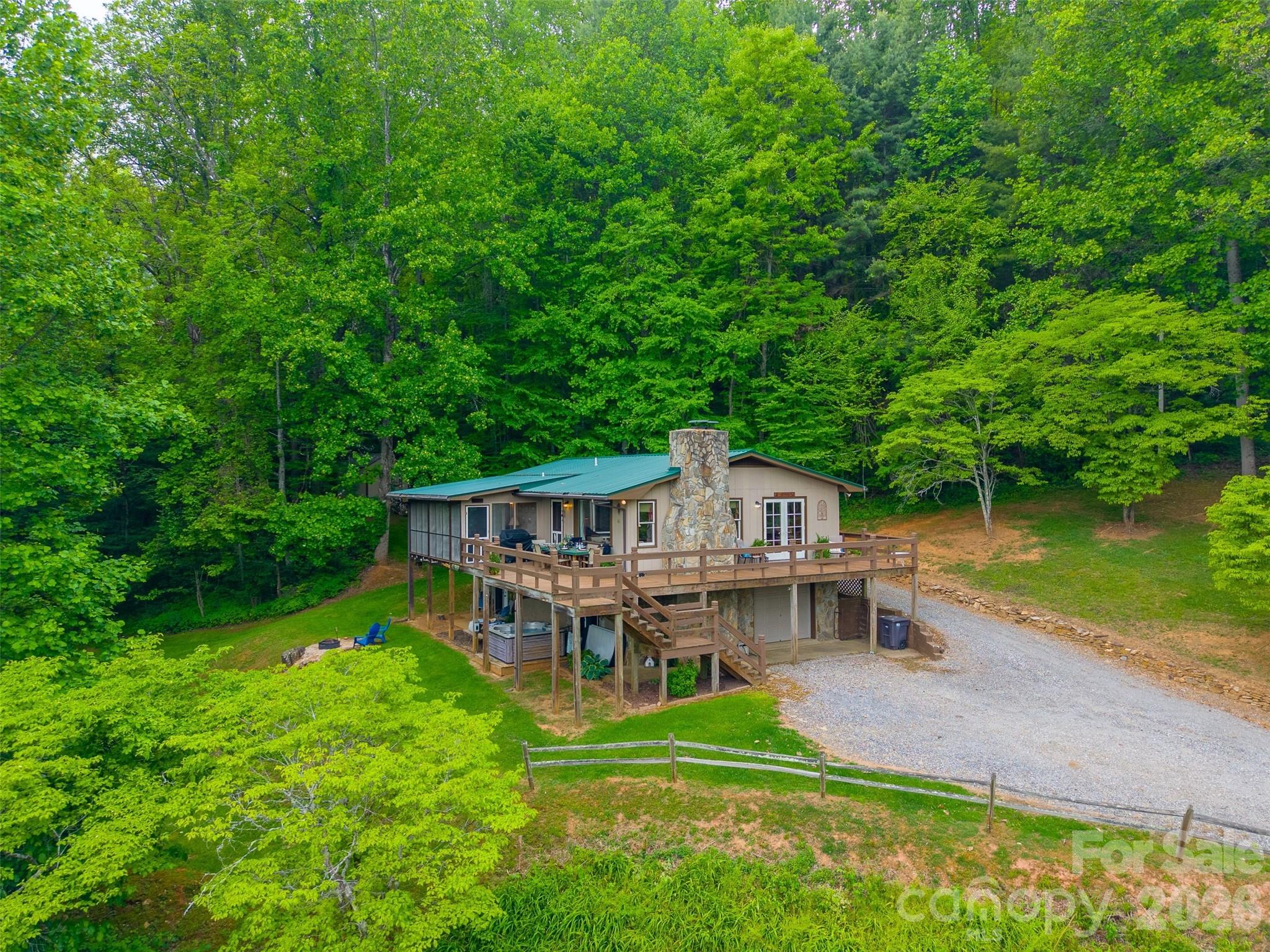 1413 Kitchens Branch Road Sylva, NC 28779 - Photo 37 of 46 an aerial view of a house with a big yard and large trees