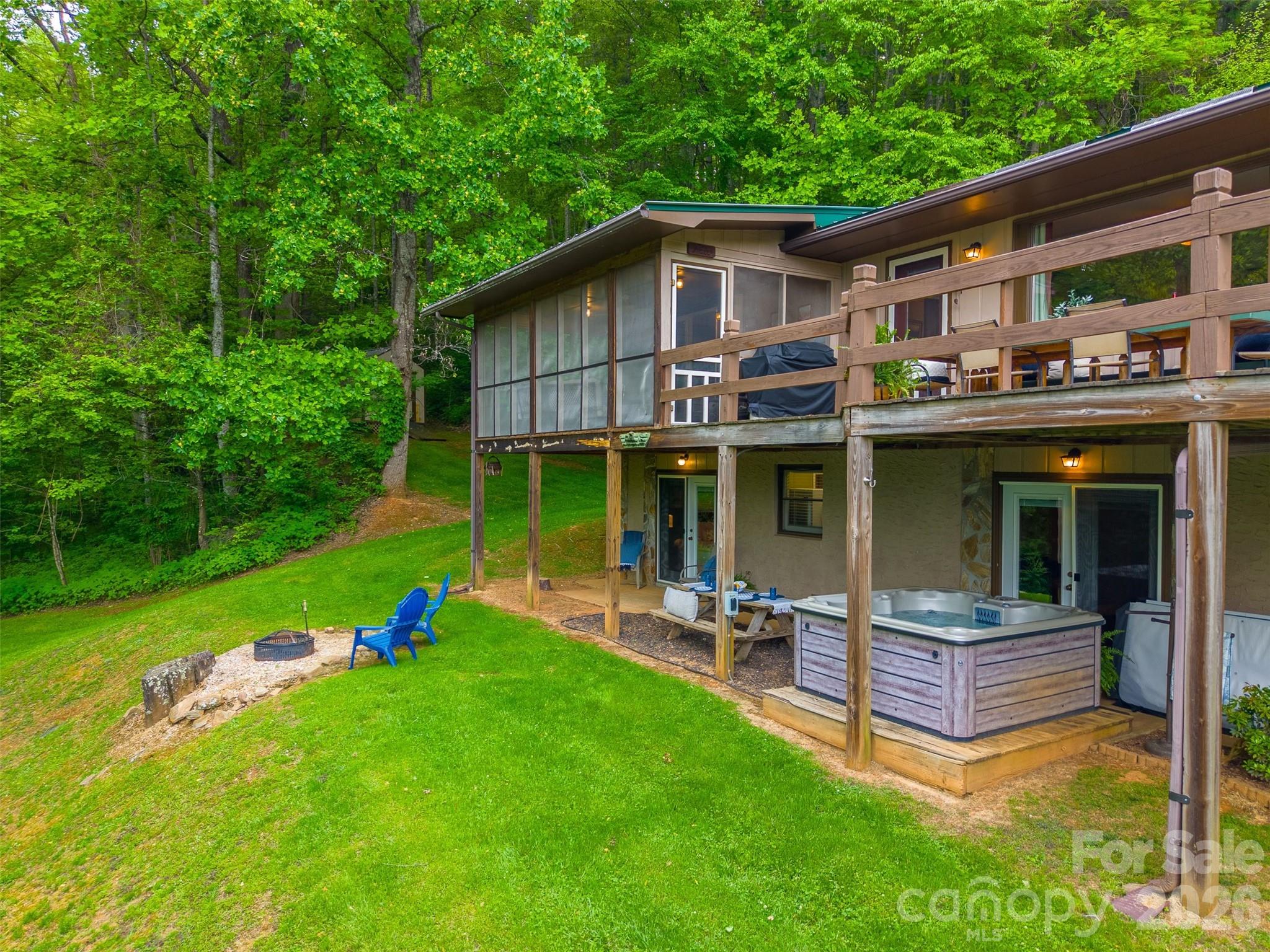 1413 Kitchens Branch Road Sylva, NC 28779 - Photo 38 of 46 front view of a house with a yard table and chairs