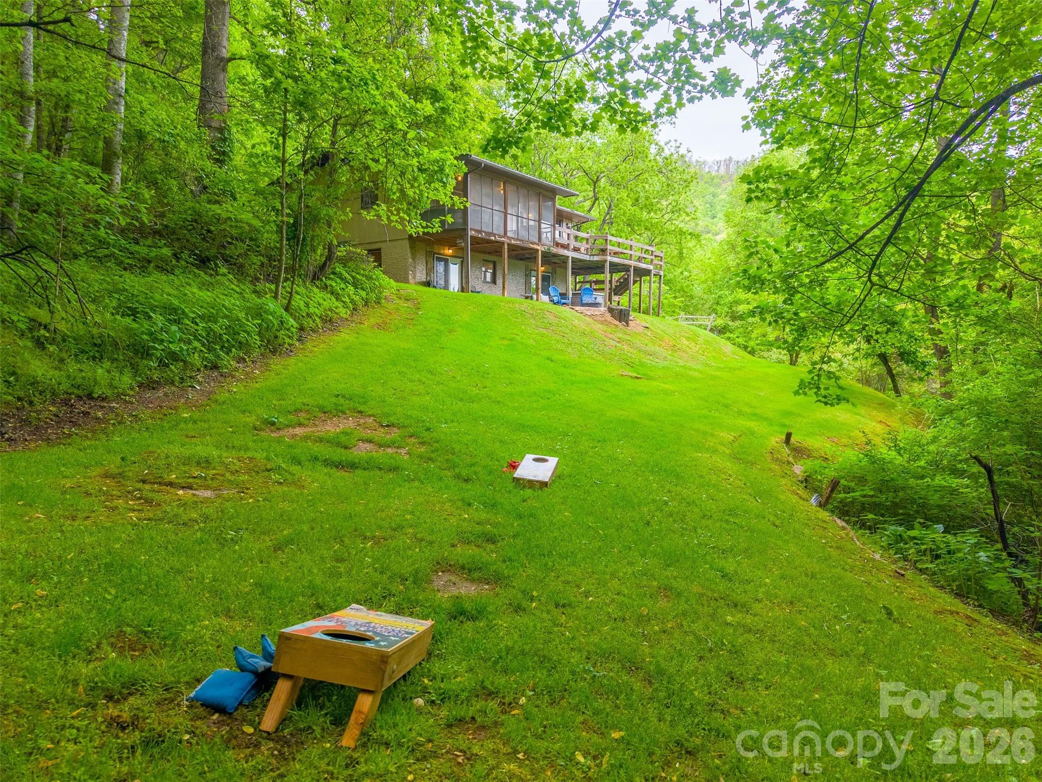 1413 Kitchens Branch Road Sylva, NC 28779 - Photo 39 of 46 a view of a backyard with a garden
