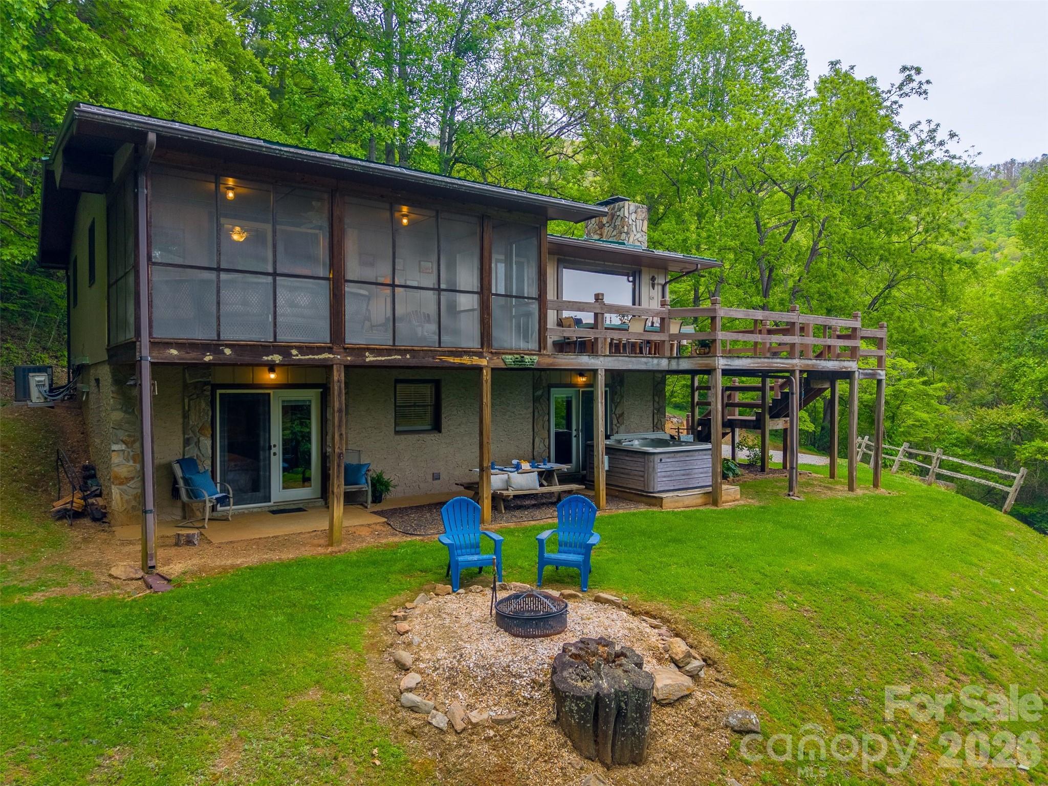 1413 Kitchens Branch Road Sylva, NC 28779 - Photo 41 of 46 a view of a house with a yard porch and sitting area