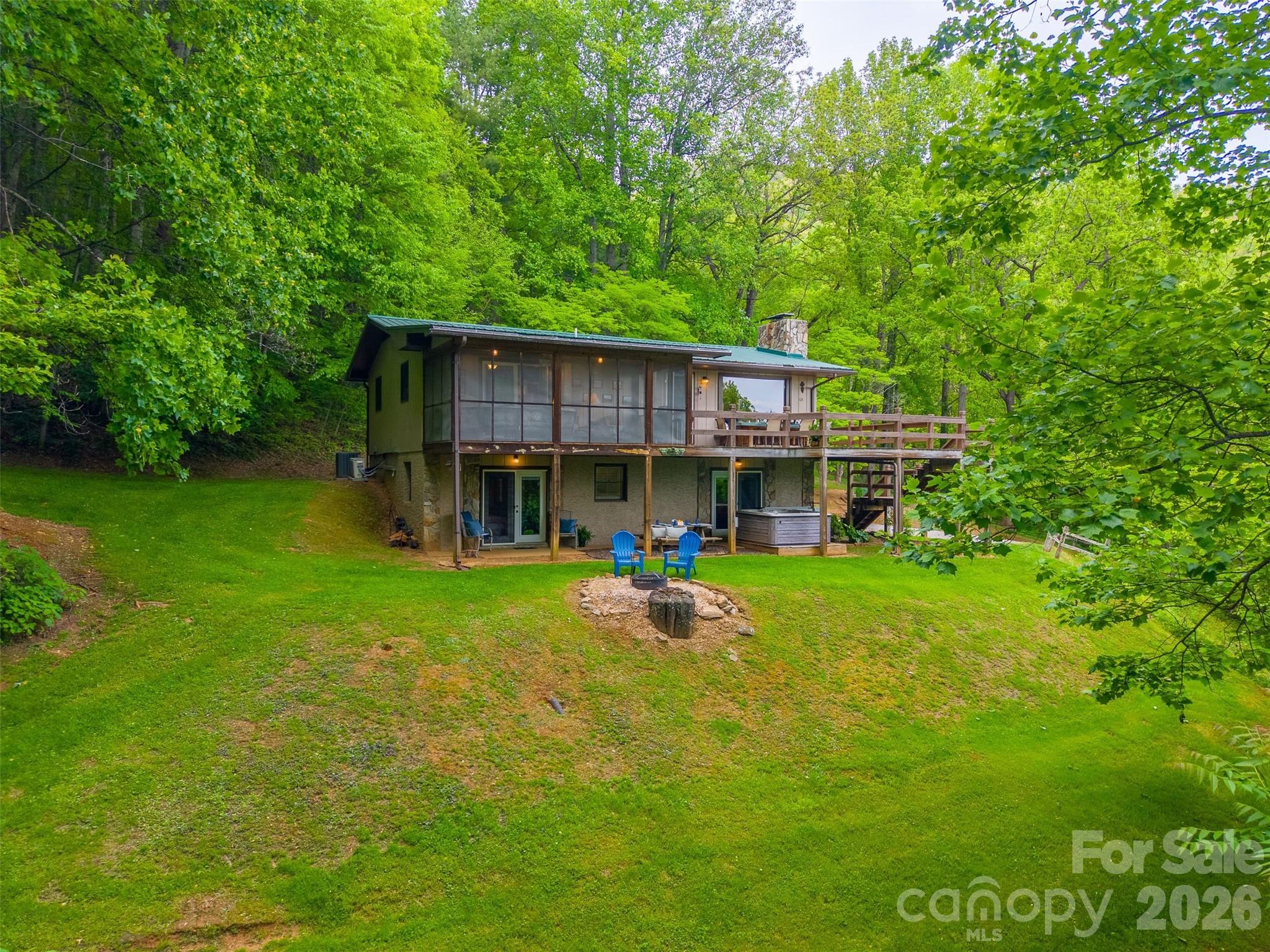 1413 Kitchens Branch Road Sylva, NC 28779 - Photo 42 of 46 a view of a house with a backyard patio and sitting area