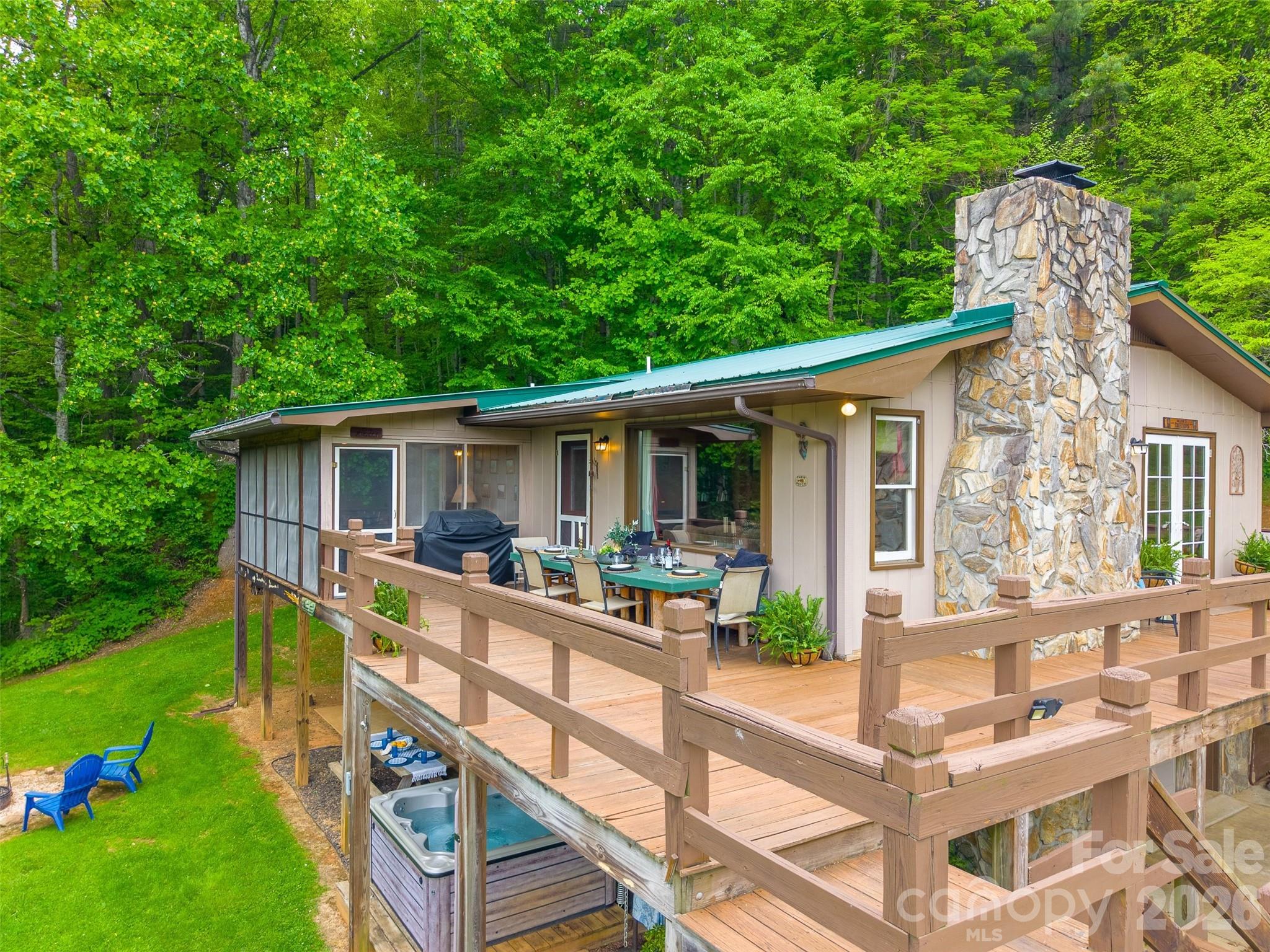 1413 Kitchens Branch Road Sylva, NC 28779 - Photo 43 of 46 a view of a house with backyard and sitting area