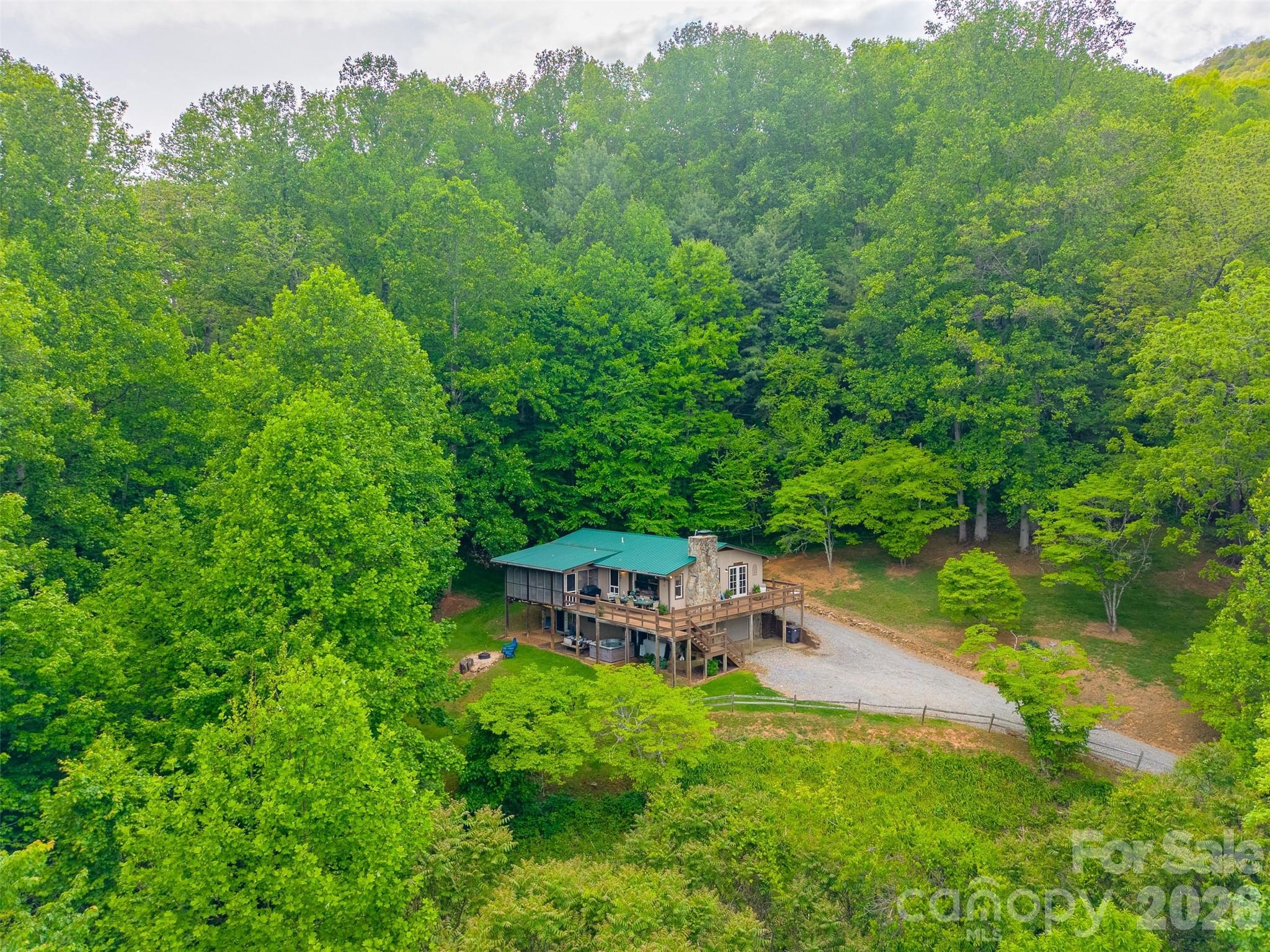 1413 Kitchens Branch Road Sylva, NC 28779 - Photo 44 of 46 a backyard of a house with table and chairs