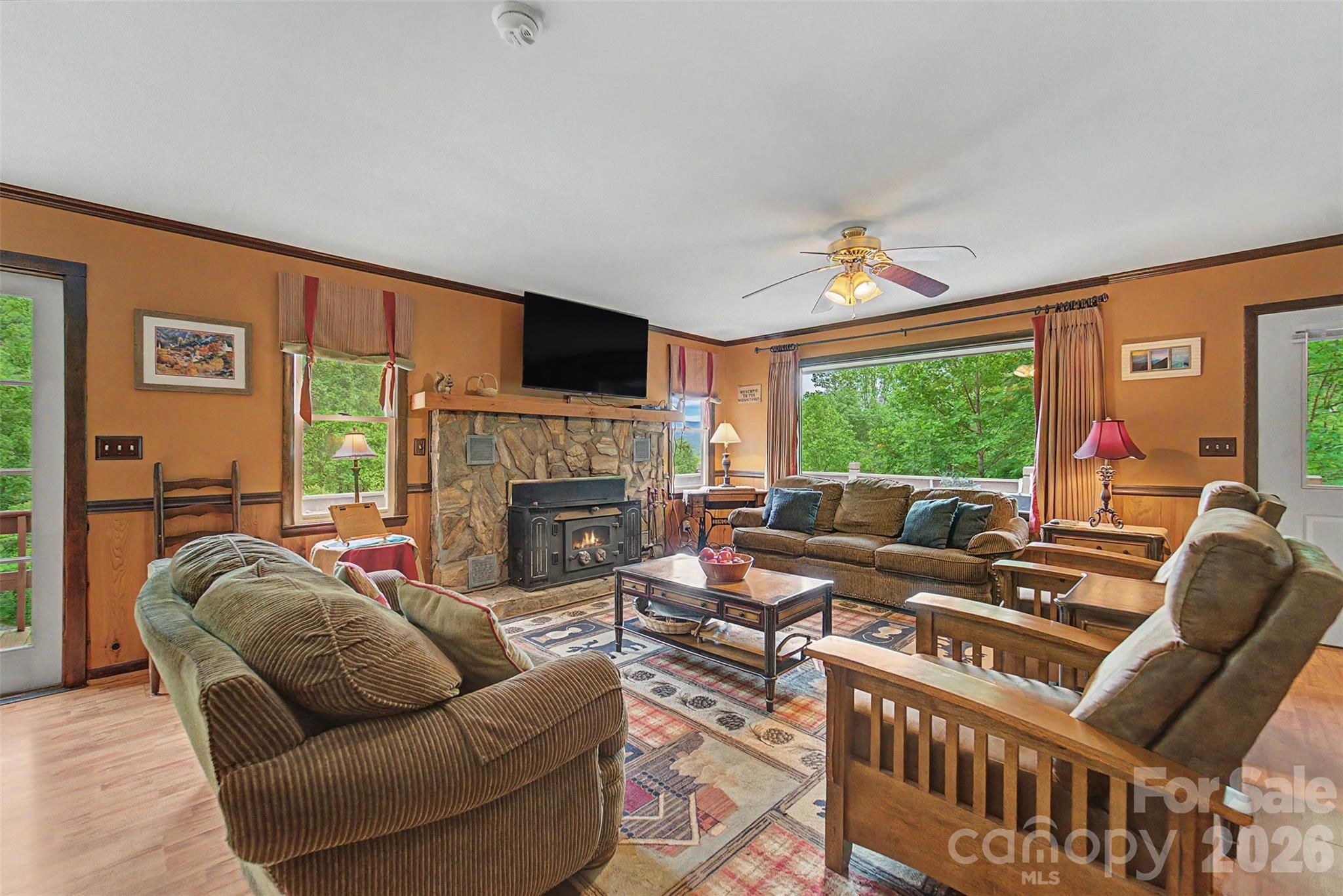 1413 Kitchens Branch Road Sylva, NC 28779 - Photo 6 of 46 a living room with furniture a large window and a fireplace