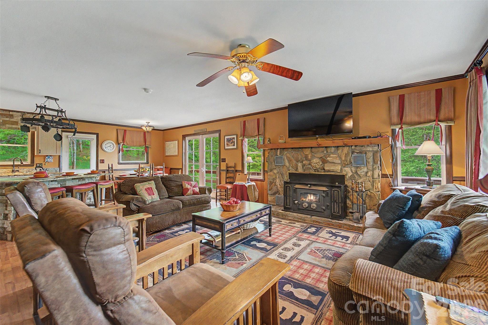 1413 Kitchens Branch Road Sylva, NC 28779 - Photo 7 of 46 a living room with furniture a fireplace and a flat screen tv