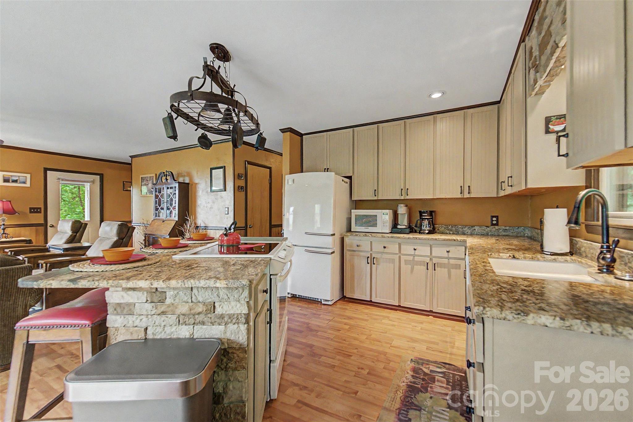 1413 Kitchens Branch Road Sylva, NC 28779 - Photo 9 of 46 a kitchen with a refrigerator and a stove top oven