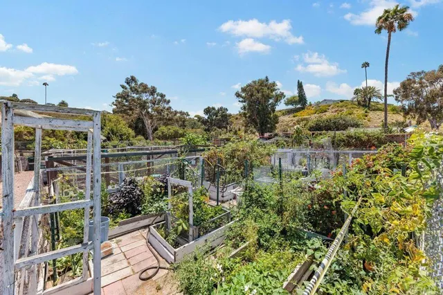 a view of a patio with a table and chairs under an umbrella