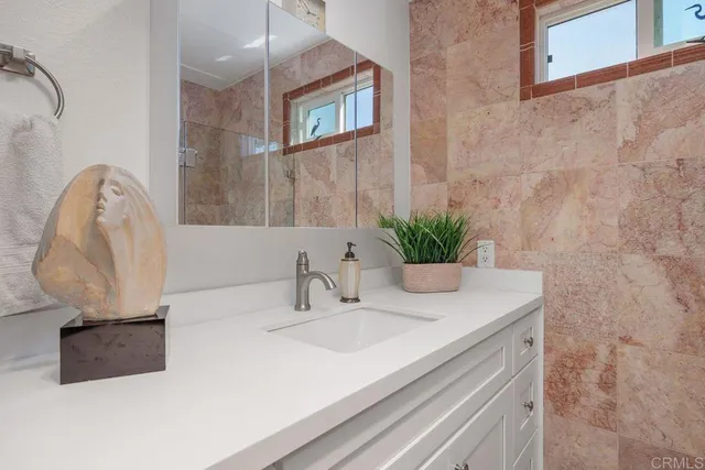 a view of a patio with table and chairs under an umbrella