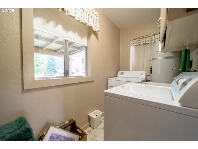 a bathroom with a sink mirror and a window