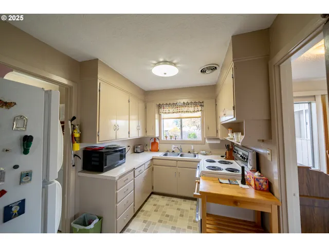 a kitchen with a sink cabinets and window