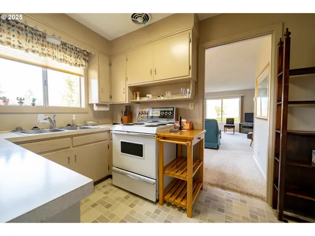 a kitchen with a sink cabinets and window