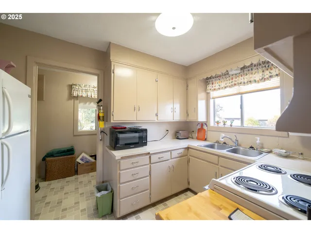 a kitchen that has a sink and a stove in it