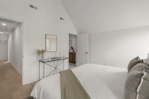 a bedroom with a bed a table and chair