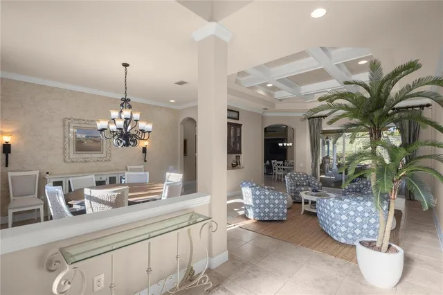 a view of a dining room with furniture and chandelier